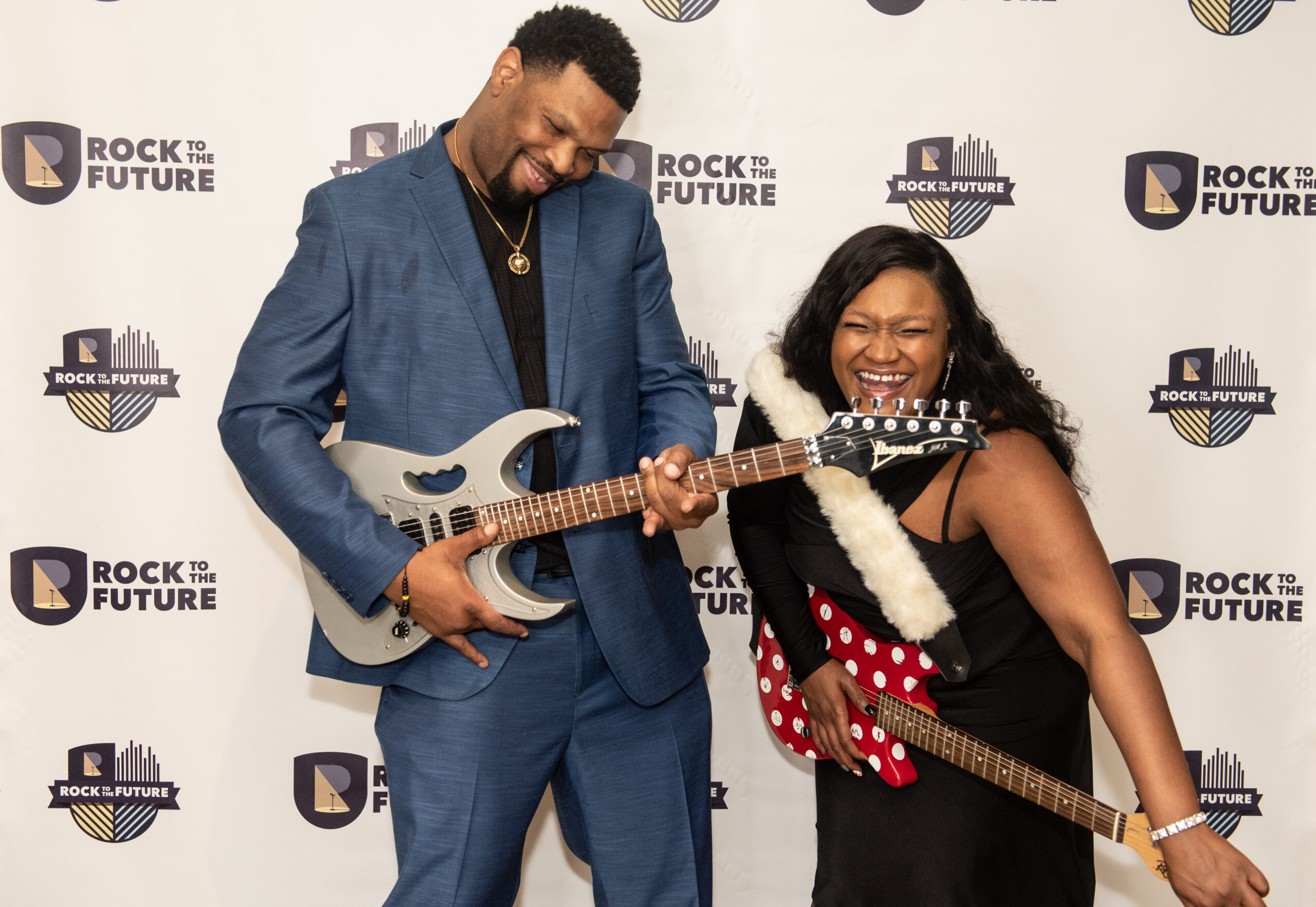 Rock to the Future family attends Music for all Ball and pose with guitars.